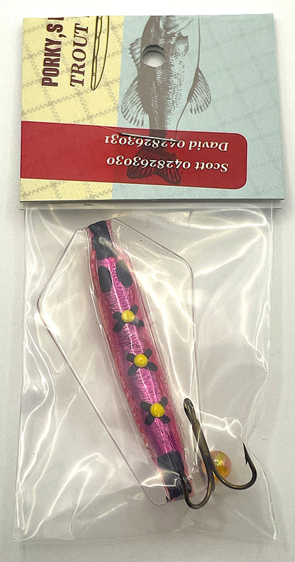 Pink and black fishing lure in clear packaging with a branded card above it.